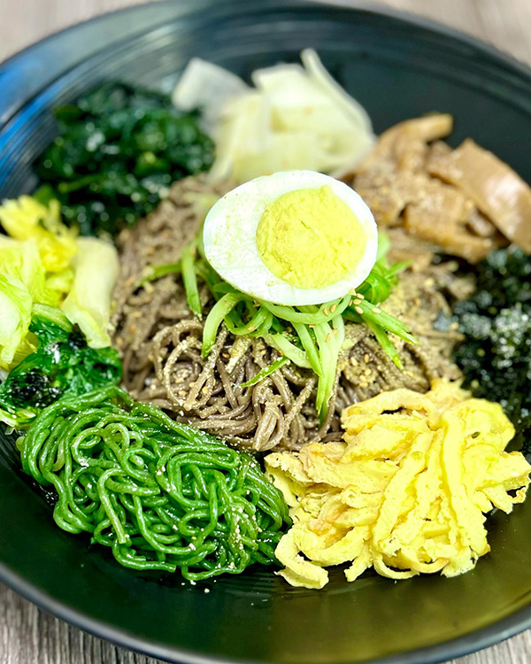 A bowl called Royal Soba with various noodles and green vegetables from Pocha Eats 