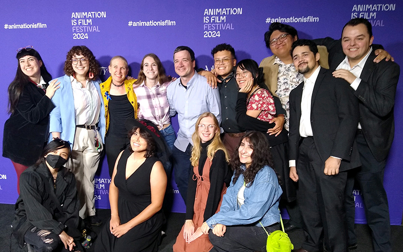 Men and women pose for a photo