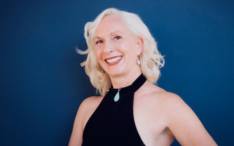 Woman smiling against blue background