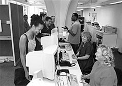 Student at Admissions and Records counter.