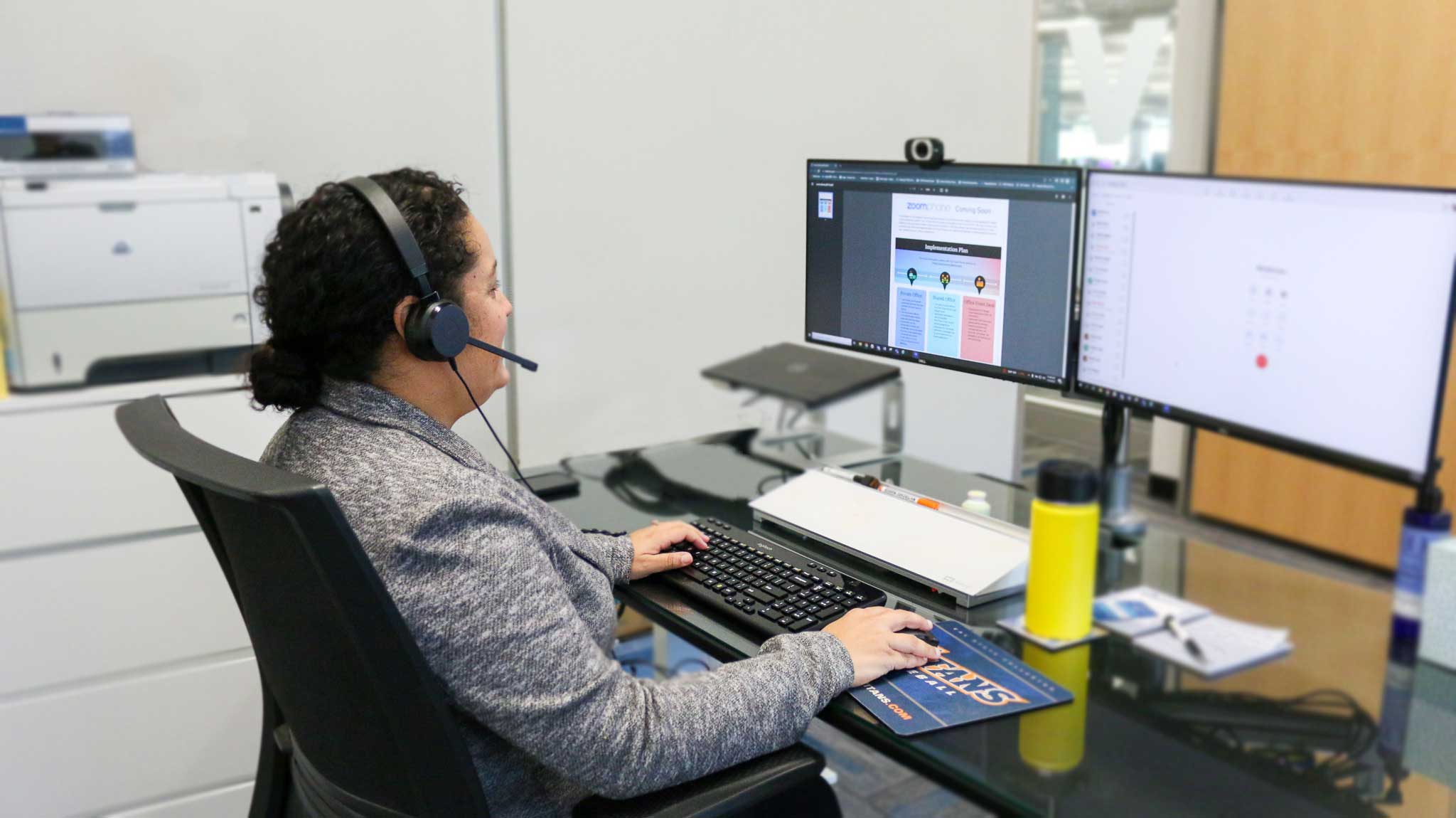 private office setting, a staff using headset with laptop to use zoom phone