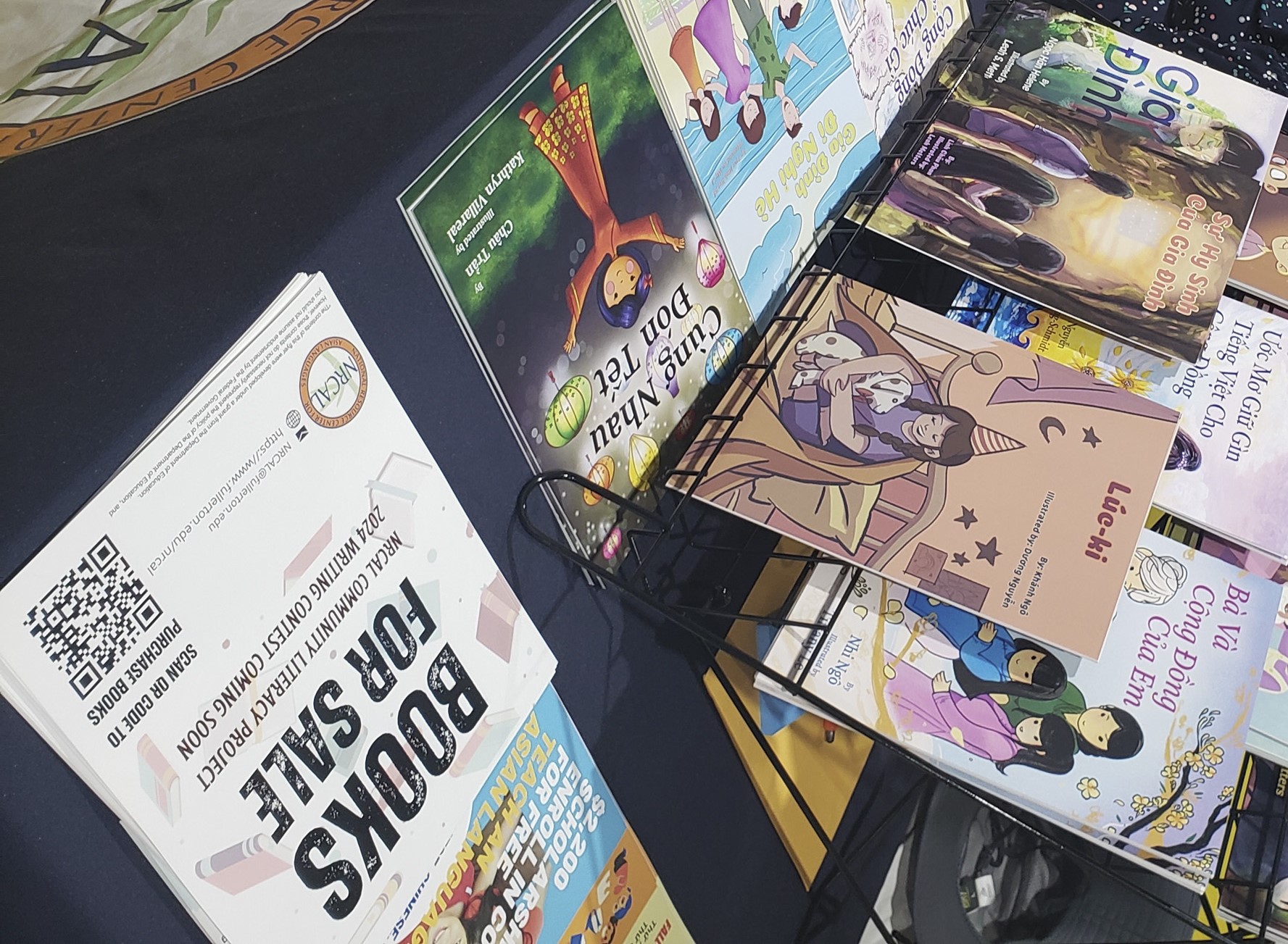 Children's books are displayed at an event.