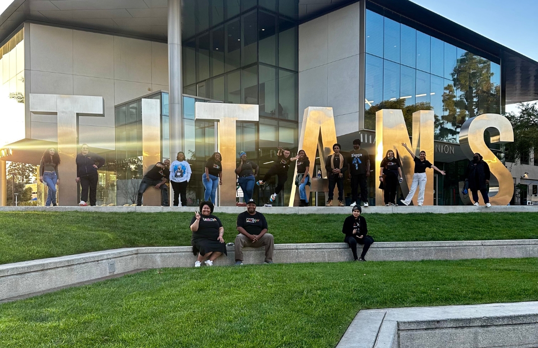 Transfer students standing near the Titan block letters